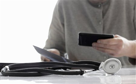 people mature lifestyle caucasian phone 50 years old - Close up of stethoscope on desk Stock Photo - Premium Royalty-Free, Code: 649-06533507