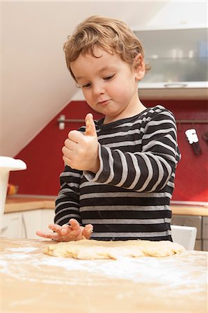 Boy kneading dough in kitchen Stock Photo - Premium Royalty-Free, Code: 649-06533522