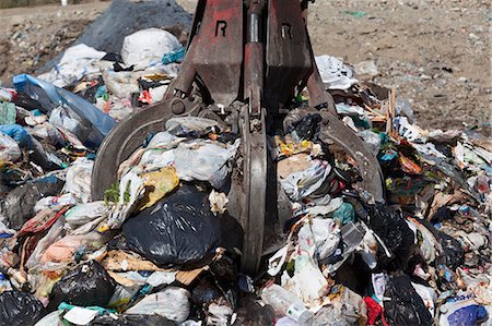 Machinery grabbing waste in landfill Stock Photo - Premium Royalty-Free, Code: 649-06533599