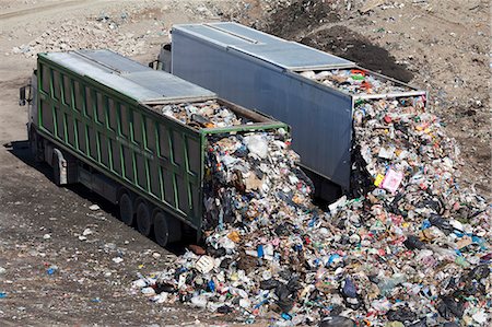 environmental pollution of garbage - Trucks dumping waste in landfill Stock Photo - Premium Royalty-Free, Code: 649-06533604