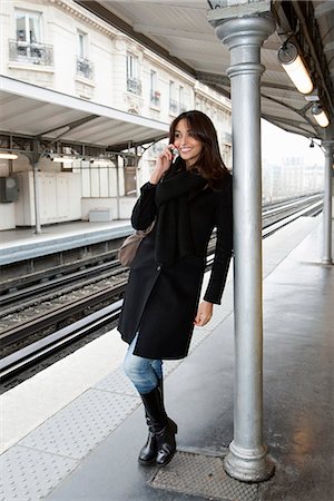 railroads - Woman on cell phone at train station Stock Photo - Premium Royalty-Free, Code: 649-06621972