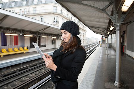 railroad station platform - Woman using tablet computer on platform Stock Photo - Premium Royalty-Free, Code: 649-06621973