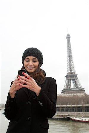 Woman using cell phone on waterfront Stock Photo - Premium Royalty-Free, Code: 649-06621984