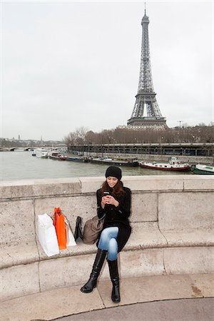 Woman using cell phone on city street Stock Photo - Premium Royalty-Free, Code: 649-06621981