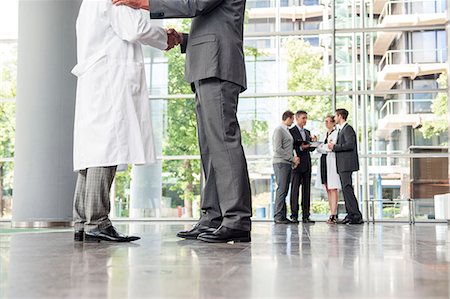 physician businessman - Businessman and doctor shaking hands Stock Photo - Premium Royalty-Free, Code: 649-06622065