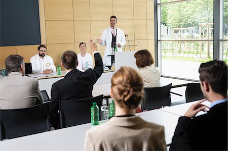 simsearch:649-06488702,k - Doctors giving talk in conference room Fotografie stock - Premium Royalty-Free, Codice: 649-06622074