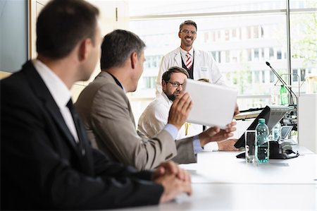 doctors meeting in conference room - Businessman using tablet computer Stock Photo - Premium Royalty-Free, Code: 649-06622078