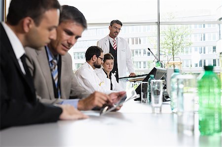 doctor meeting with business man - Business people talking at desk Stock Photo - Premium Royalty-Free, Code: 649-06622079