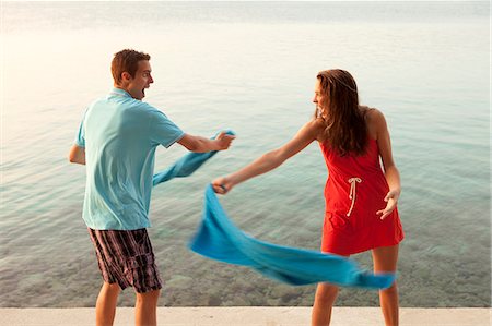 Couple snapping towels at each other Stock Photo - Premium Royalty-Free, Code: 649-06622347