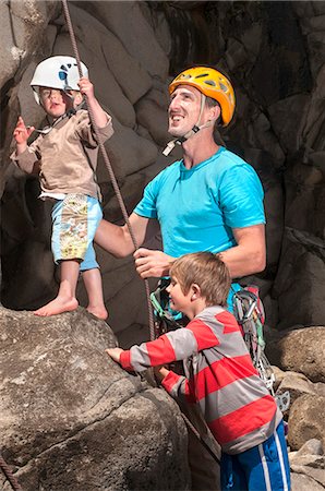 Man teaching children to rock climb Stock Photo - Premium Royalty-Free, Code: 649-06622368