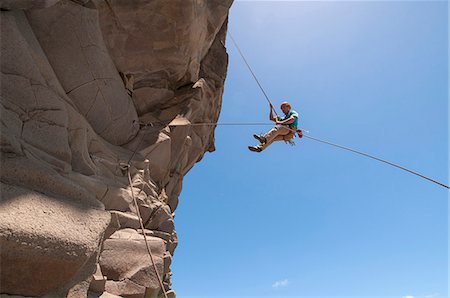 simsearch:6122-07692933,k - Rock climber abseiling jagged cliff Photographie de stock - Premium Libres de Droits, Code: 649-06622373