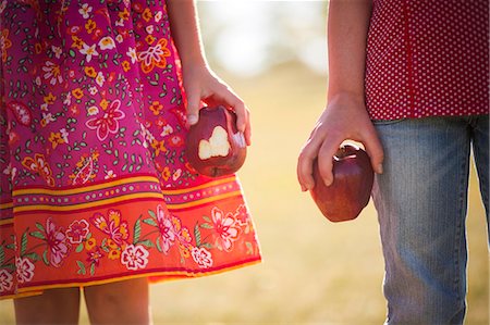 reno - Girls holding apples outdoors Stock Photo - Premium Royalty-Free, Code: 649-06622481