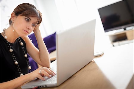 simsearch:649-06622544,k - Businesswoman working on laptop Stock Photo - Premium Royalty-Free, Code: 649-06622524