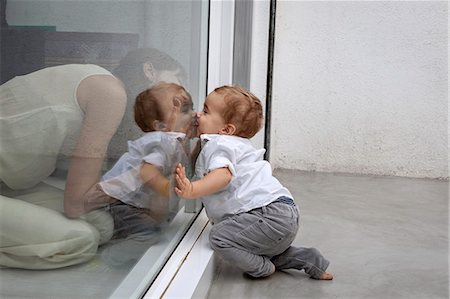 parents, conversation - Mother and son kissing through glass Stock Photo - Premium Royalty-Free, Code: 649-06622554