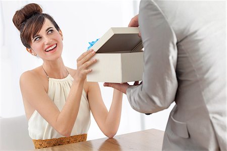 Man giving smiling girlfriend present Stock Photo - Premium Royalty-Free, Code: 649-06622570