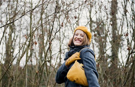 Smiling woman walking in forest Fotografie stock - Premium Royalty-Free, Codice: 649-06622602