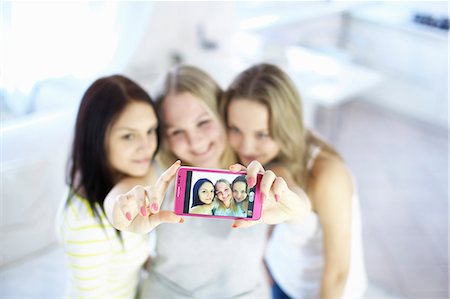 selfie cell phone indoor - Teenage girls taking picture together Stock Photo - Premium Royalty-Free, Code: 649-06622657