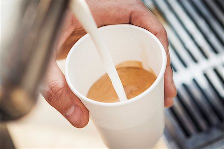 Close up of milk pouring into coffee cup Stock Photo - Premium Royalty-Free, Code: 649-06622987