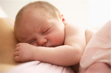 exhausted mother with baby - Baby girl sleeping on her mother Stock Photo - Premium Royalty-Free, Code: 649-06623019