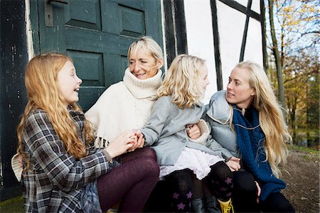 senior friends laughing - Mother and daughters sitting outdoors Stock Photo - Premium Royalty-Free, Code: 649-06623080