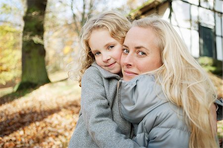 Mother and daughter hugging outdoors Stock Photo - Premium Royalty-Free, Code: 649-06623081