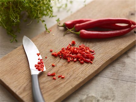 raw ingredients on board - Knife with chopped chili pepper Stock Photo - Premium Royalty-Free, Code: 649-06623157