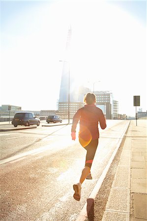 Woman running on city street Stock Photo - Premium Royalty-Free, Code: 649-06716528