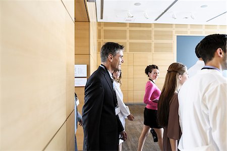 simsearch:649-06622062,k - Business people walking into conference Stock Photo - Premium Royalty-Free, Code: 649-06716709