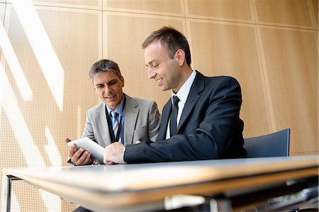 people office two man - Businessmen using tablet computer at desk Stock Photo - Premium Royalty-Free, Code: 649-06716755