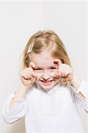 Smiling girl making a face Stock Photo - Premium Royalty-Free, Code: 649-06716780