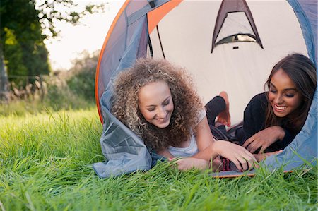 Teenage girls laying in tent at campsite Stock Photo - Premium Royalty-Free, Code: 649-06716847