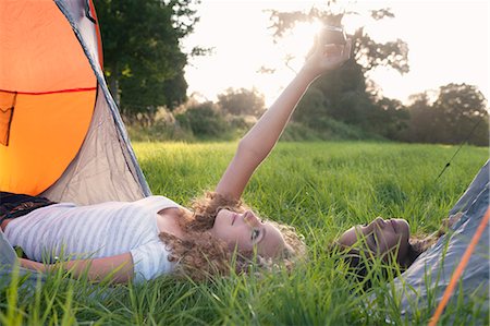 Teenage girls taking picture at campsite Stock Photo - Premium Royalty-Free, Code: 649-06716843