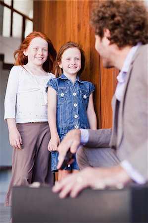 family standing in doorway - Businessman saying goodbye to daughters Stock Photo - Premium Royalty-Free, Code: 649-06716958