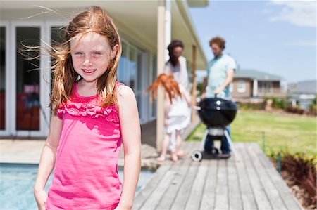 sundeck - Girl smiling on backyard patio Stock Photo - Premium Royalty-Free, Code: 649-06716987