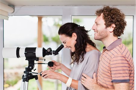 person standing profile - Woman using boyfriends telescope Stock Photo - Premium Royalty-Free, Code: 649-06717020