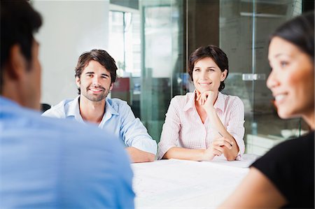 people sitting at a table - Business people smiling in meeting Stock Photo - Premium Royalty-Free, Code: 649-06717105