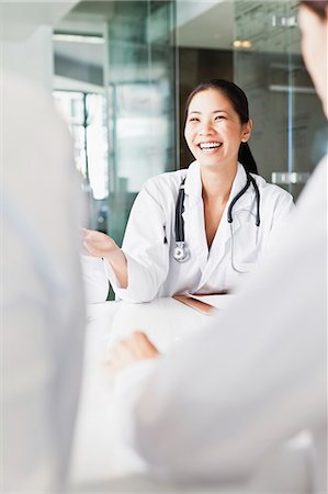 simsearch:649-08745361,k - Doctor talking to colleagues in meeting Stock Photo - Premium Royalty-Free, Code: 649-06717111