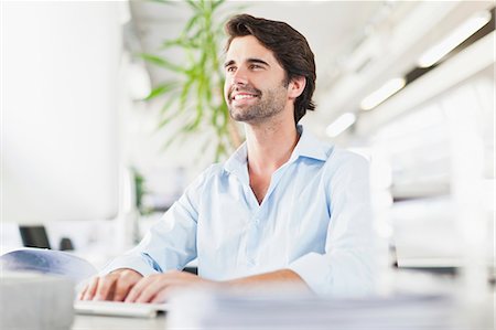 smiling computer office copy space - Businessman working on computer Stock Photo - Premium Royalty-Free, Code: 649-06717135