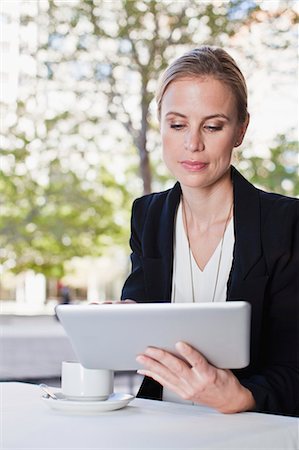 eyes lowered - Businesswoman using tablet computer Stock Photo - Premium Royalty-Free, Code: 649-06717155
