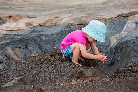 Toddler girl playing in sand on beach Photographie de stock - Premium Libres de Droits, Code: 649-06717314