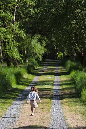 denmark girl - Girl walking on rural road Stock Photo - Premium Royalty-Free, Code: 649-06717359