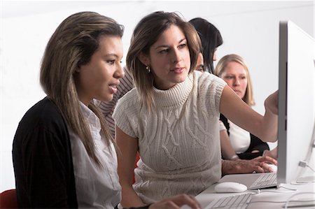 student meeting - Teacher helping student use computer Stock Photo - Premium Royalty-Free, Code: 649-06717374