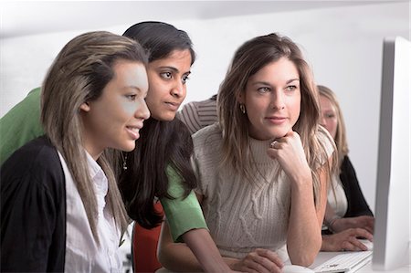 female students - Teacher helping student use computer Stock Photo - Premium Royalty-Free, Code: 649-06717375