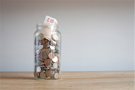 Savings jar on desk Stock Photo - Premium Royalty-Free, Code: 649-06717471