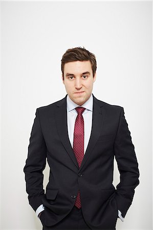 portrait young man white background - Businessman standing with hands in pockets Stock Photo - Premium Royalty-Free, Code: 649-06717565