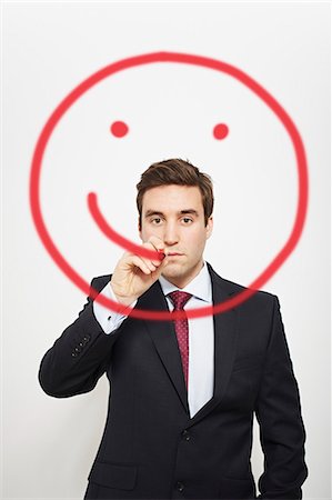 portrait concept - Businessman drawing smiley face in air Stock Photo - Premium Royalty-Free, Code: 649-06717575