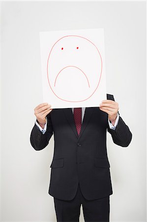 paper cut-out - Businessman holding sad face over his face Stock Photo - Premium Royalty-Free, Code: 649-06717576