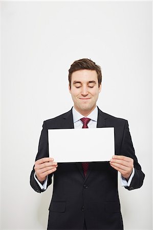 person with placard - Businessman holding blank card Stock Photo - Premium Royalty-Free, Code: 649-06717570