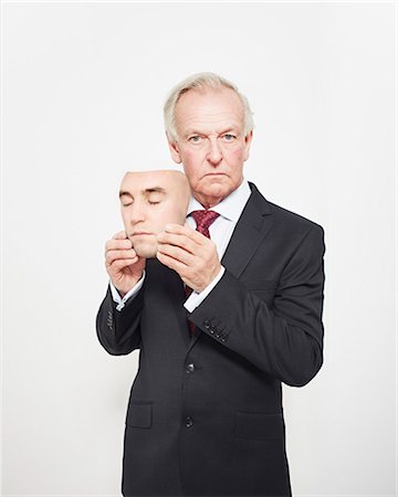 Businessman holding mask Foto de stock - Sin royalties Premium, Código: 649-06717588