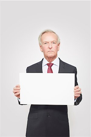 sign - Businessman holding blank card Stock Photo - Premium Royalty-Free, Code: 649-06717593